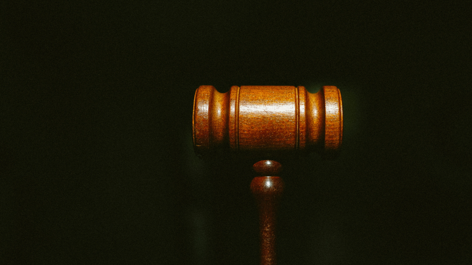 a gavel on black backround